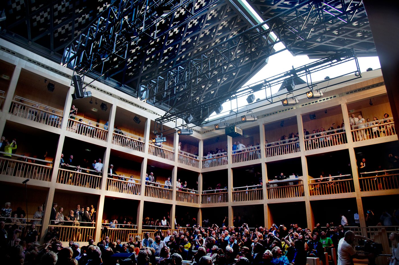 A large rectangular galleried theatred, with a roof that can partially open.