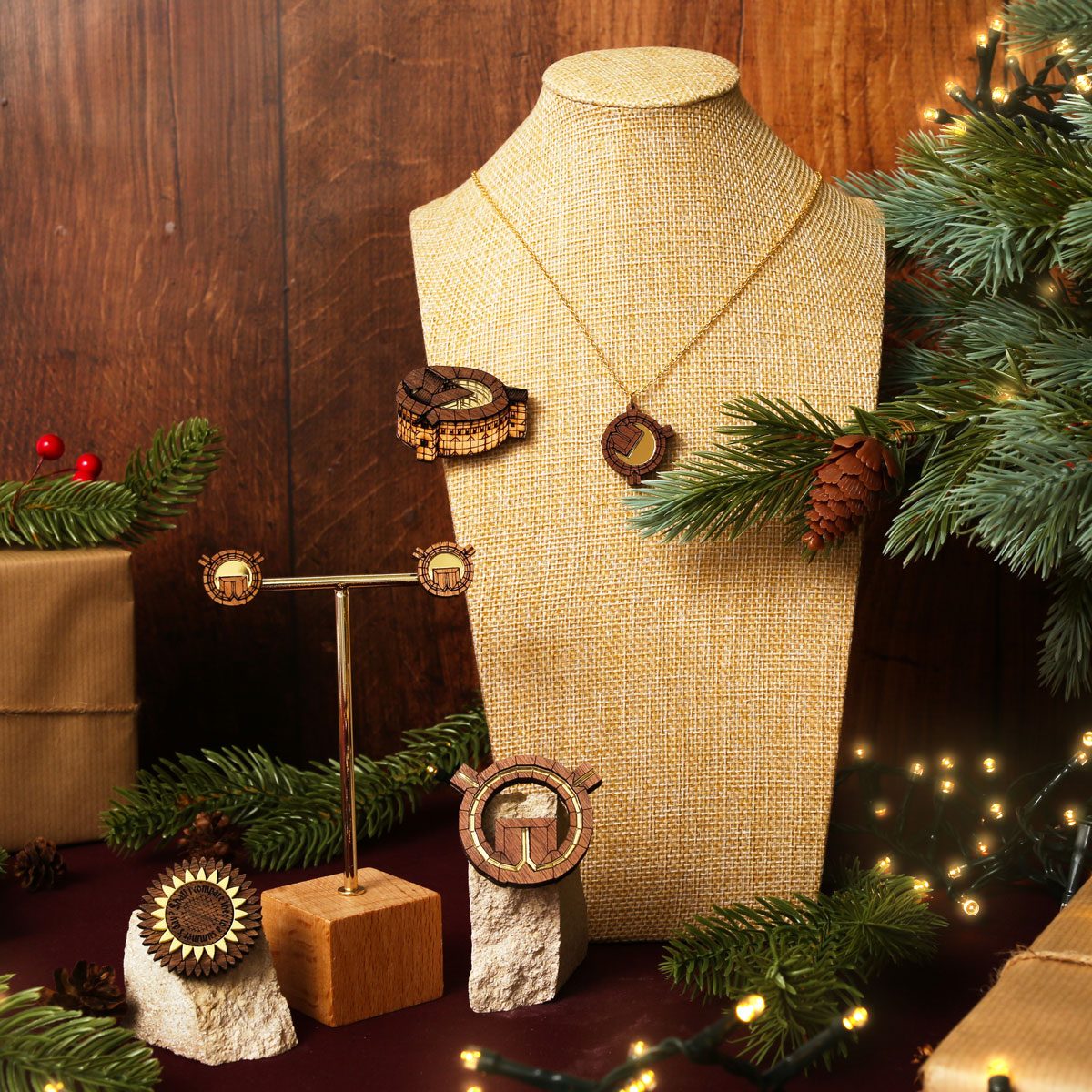 A collection of Globe Theatre themed jewellery is displayed on a mannequin and framed by festive decorations.