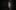 Two unlit candles in the shadows.