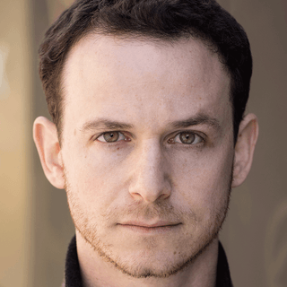 An actor looking into the camera.
